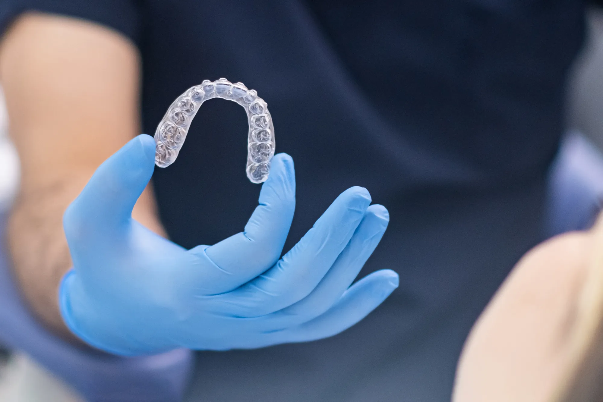dental-professional-holding-clear-teeth-alignment-2026-03-13-01-41-16-utc Ortodonzia - Olbia Dental Studio - Estetica Dentale e Implantologia Avanzata